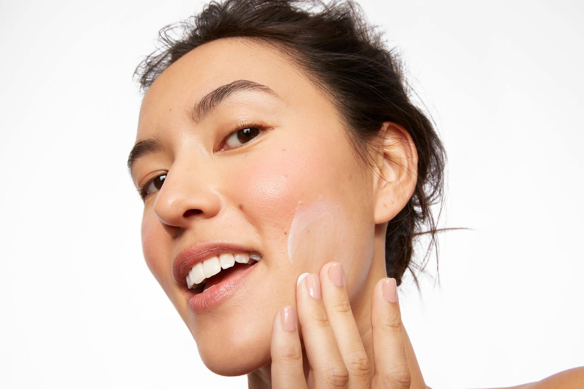 Beauty Pie model applying face cream