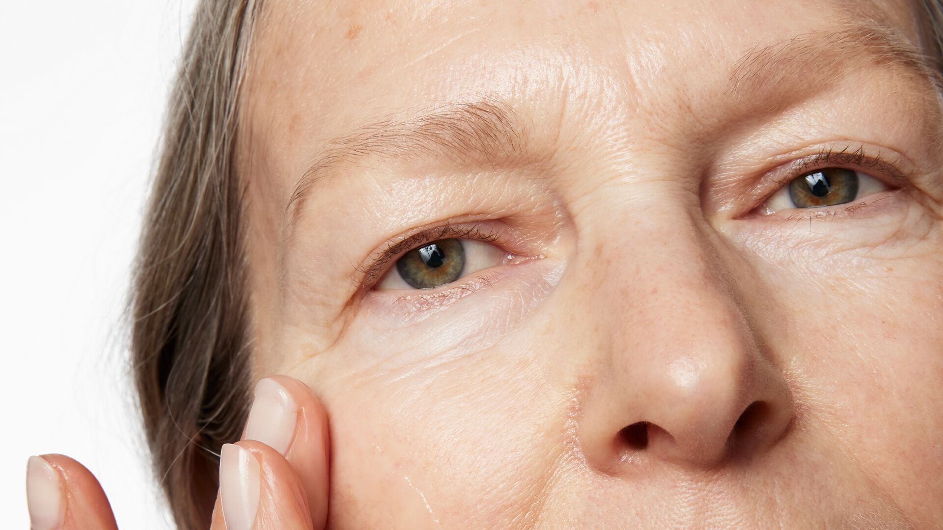 eyecream-hero.jpg Image of a woman applying eye cream