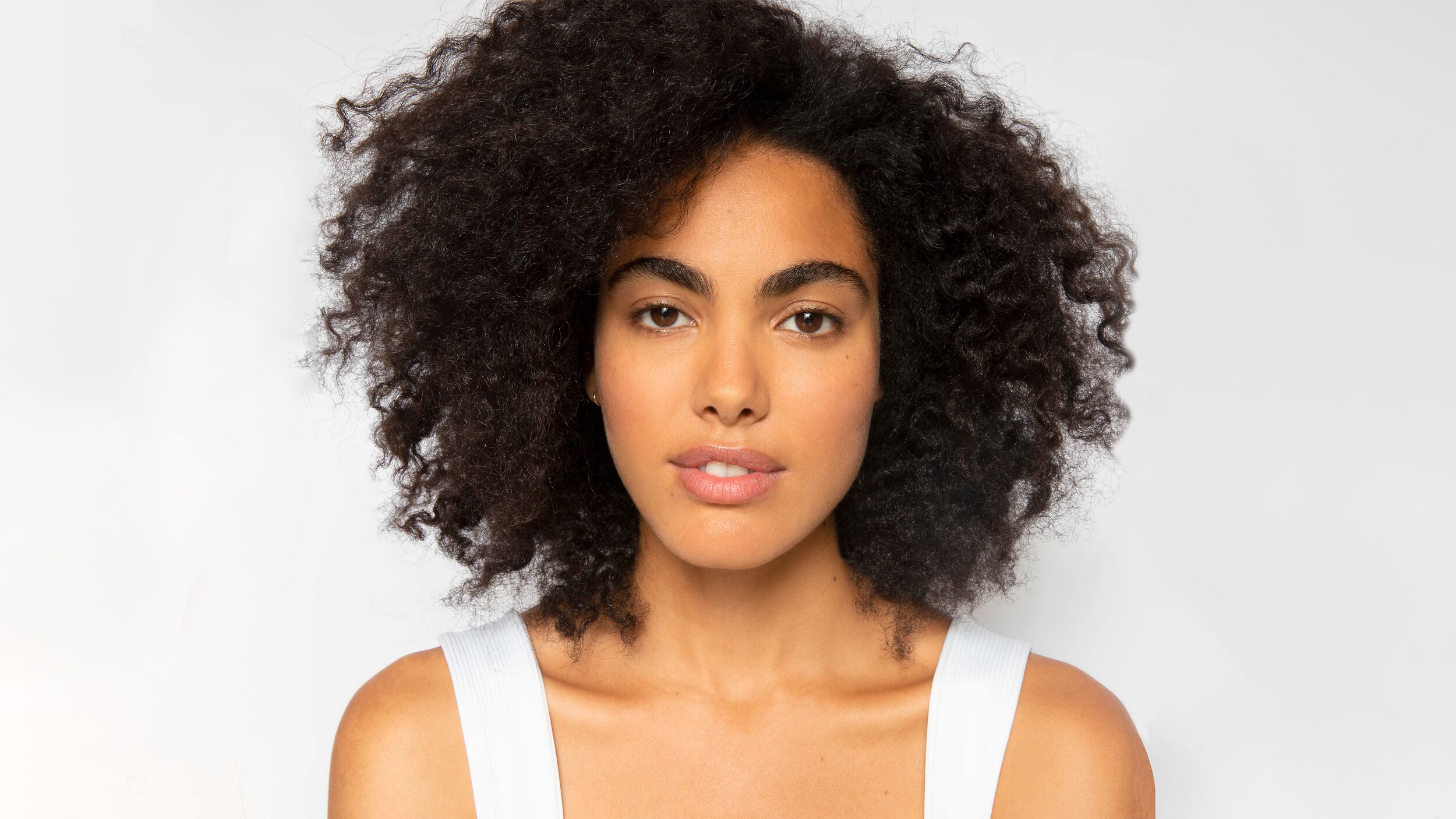 hair-conditioning-hero.jpg Woman with thick dark hair staring into the camera