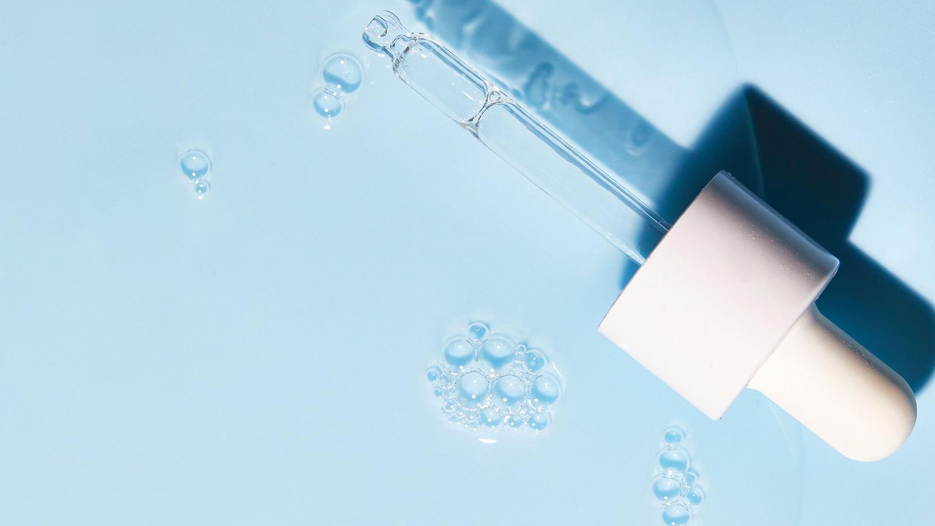 Serum pipette with a blue background