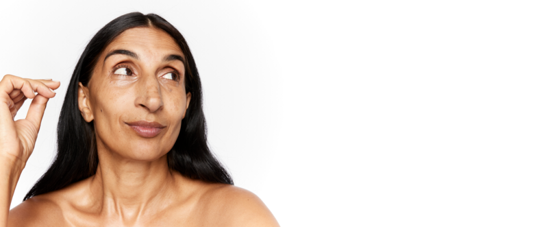 menopause-blog-desktop.jpg Woman with an electric brush doing skincare